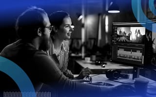 Two content creators editing a video on a computer screen.