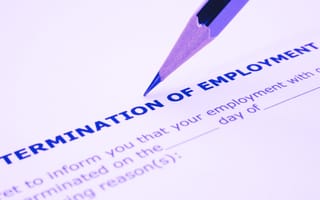 Creating an Employee Termination Policy The tip of a pencil rests on a termination of employment agreement.