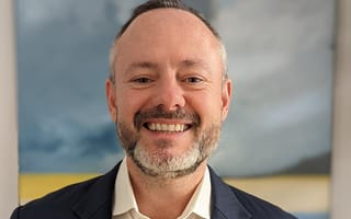 A picture of Ampersand president Mike Dean is shown..