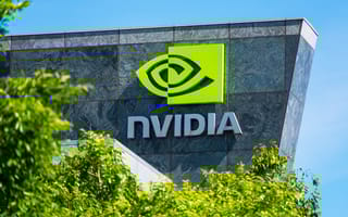NVIDIA logo on a building with an angular shape. Trees in the foreground.