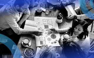 A group of people gathered around a work document in a coffee shop.