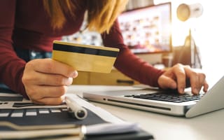 A person makes an online purchase using a laptop.
