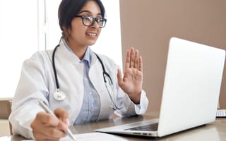 A doctor connects with a patient through a telehealth.