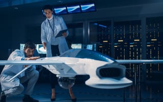 Two engineers look at a drone.