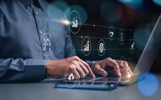 Person works on a computer with marketing holograms.
