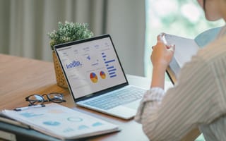 A person looks at marketing data on a laptop screen.