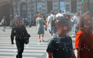 A photo of people walking down the street with their faces blurred out and labeled with squares.