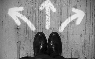 dress shoes standing above multiple arrows on the floor