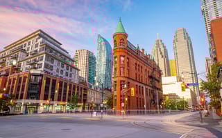 Street view of a downtown Toronto intersection looking up at the tall buildings.