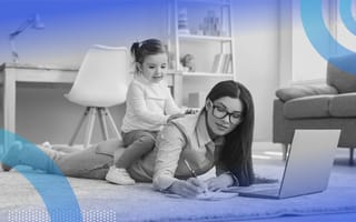 A woman lying on the floor writing on a notepad with an open laptop in front of her and a little girl on her back.