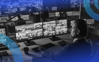 A person looking at images of a port on computer screens.