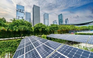 A large city filled with buildings and solar panels.