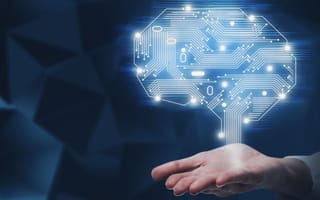 A hand holds a hologram of a brain.