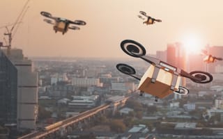 Drones deliver packages in a large city.