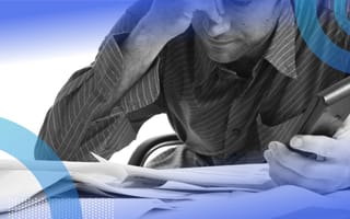 A person overwhelmed with financial paperwork.