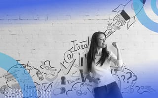 A young woman fist pumps in front of a painting of inspirational words and a rocket