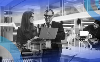 A chief artificial intelligence officer consulting with an employee in the office.