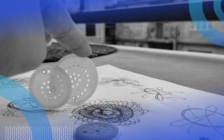 A hand holding Spirograph discs on a paper filled with designs.