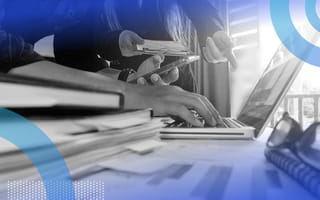 A closeup of strategy documents and a laptop with a product manager working
