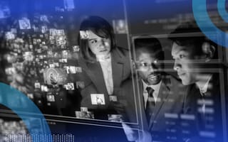 Three people in conversation while looking at holographic data.