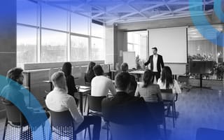 Employees at a learning and development session in a windowed conference room.