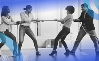 Four people playing tug-of-war at work.