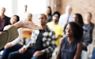 An instructor leads sensitivity training at a workplace.