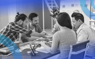marketers reviewing data and brainstorming around table