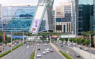 A photo of evening traffic underneath skyscrapers in Gurgaon.