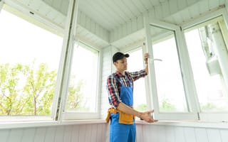 A person is shown installing windows.