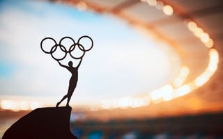 The silhouette of an Olympic statue is pictured.