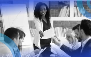 Leader delegating tasks to employees at a table