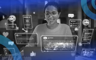 A smiling woman engaging with holographic representation of IoT.