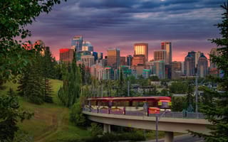 Sunset skyline view of Calgary. A tram is in the foreground.