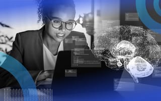 A Black woman with glasses works at a computer with a stylized image of a brain overlaid