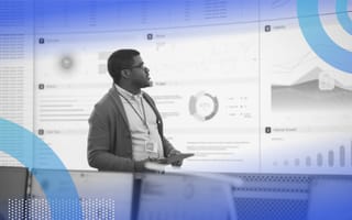 A young, Black product manager presents a screen full of data and analytics