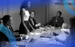 A Black woman is giving a presentation at a board meeting.