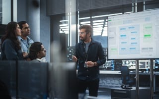 A diverse group of engineers having a meeting in a high-tech conference room