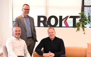 Rokt executive team members pose together for a photo.