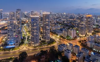 A photo of skyscrapers in Tel Aviv at night.