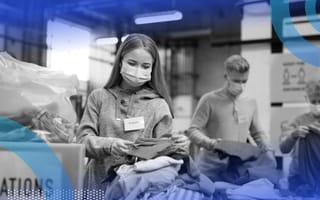 Masked individuals sorting clothing donations.