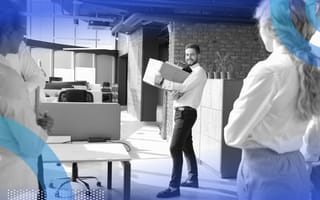 A person holding a box is saying goodbye to colleagues.