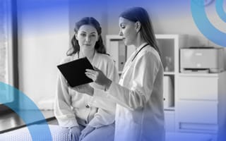 Doctor reviewing patient information on tablet with patient