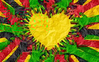 Paper multicolored hands forming shape of a heart in honor of Juneteenth