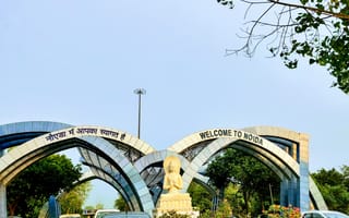 An arch welcoming people and citizens of India to Noida stating welcome to Noida. end of Delhi and beginning of Noida.