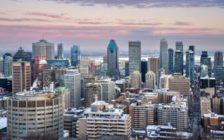 An aerial view of the Montreal, Quebec skyline featuring an assortment of tall buildings.