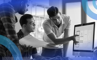Three people are looking at a computer screen that shows a prototype app