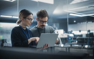 Two engineers analyze code.