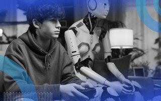A teenage boy and a robot play a video game on a couch