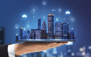 hand holding model of smart city